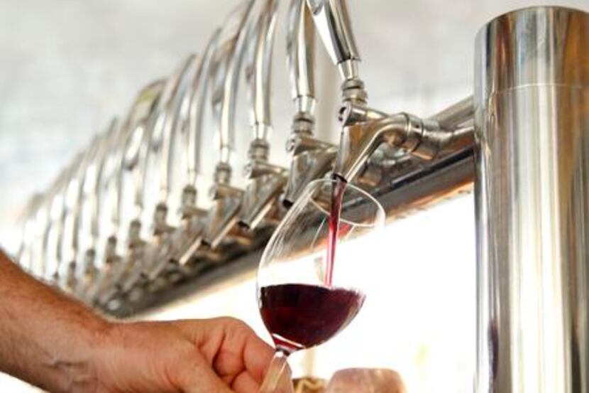 
Savor chef John Coleman pours a glass of Pinot Grigio from the tap which is fed from the...