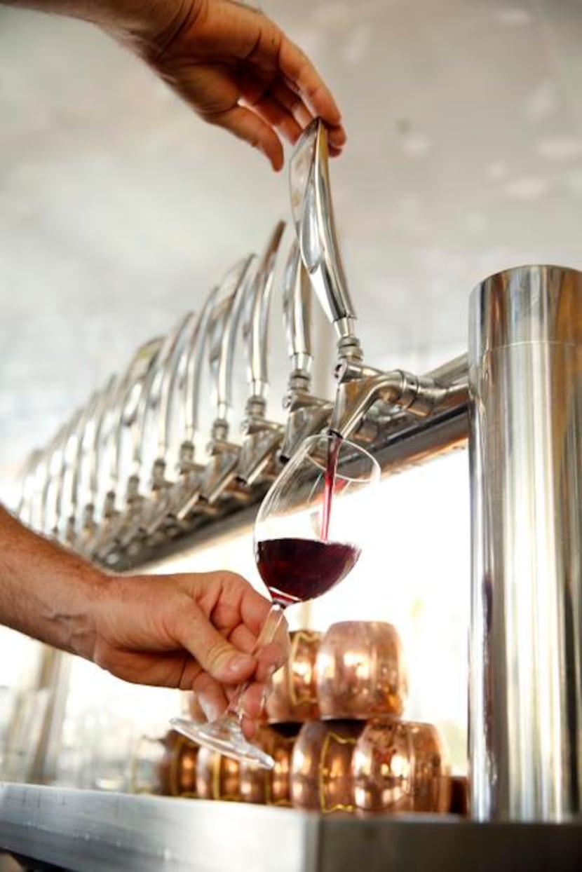 
Savor chef John Coleman pours a glass of Pinot Grigio from the tap which is fed from the...