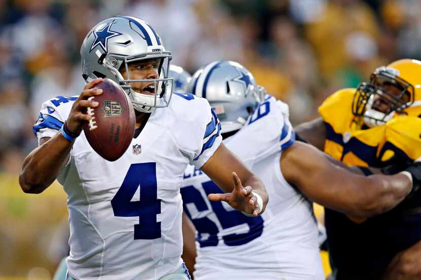 Dallas Cowboys quarterback Dak Prescott scrambles under pressure during Dallas' 30-16 win...