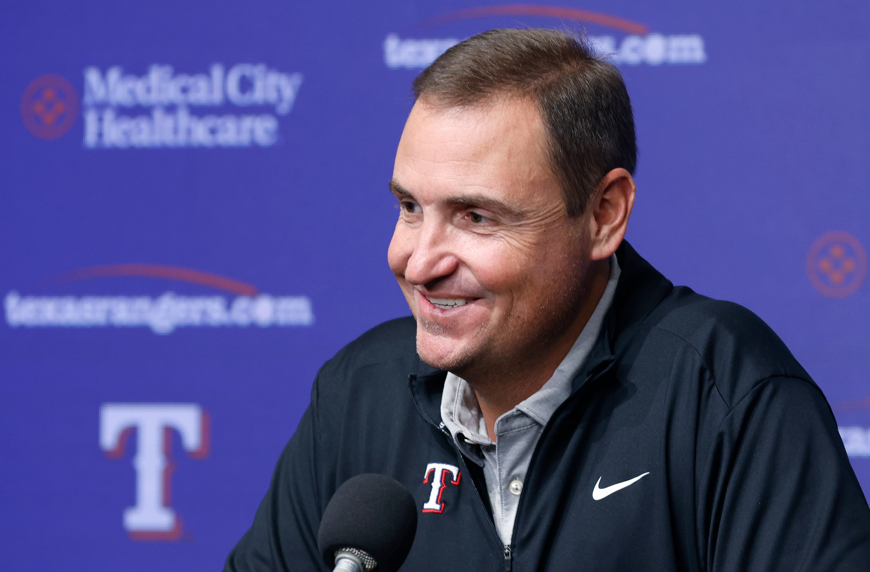 Texas Rangers general manager Chris Young reacts to a reporters question during a post...