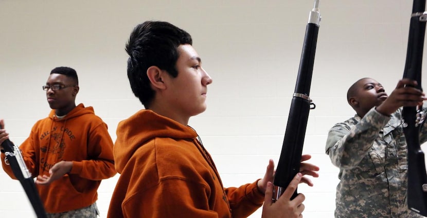 
Christopher Martinez (center,) participates in an Armed Exhibition Drill with fellow...