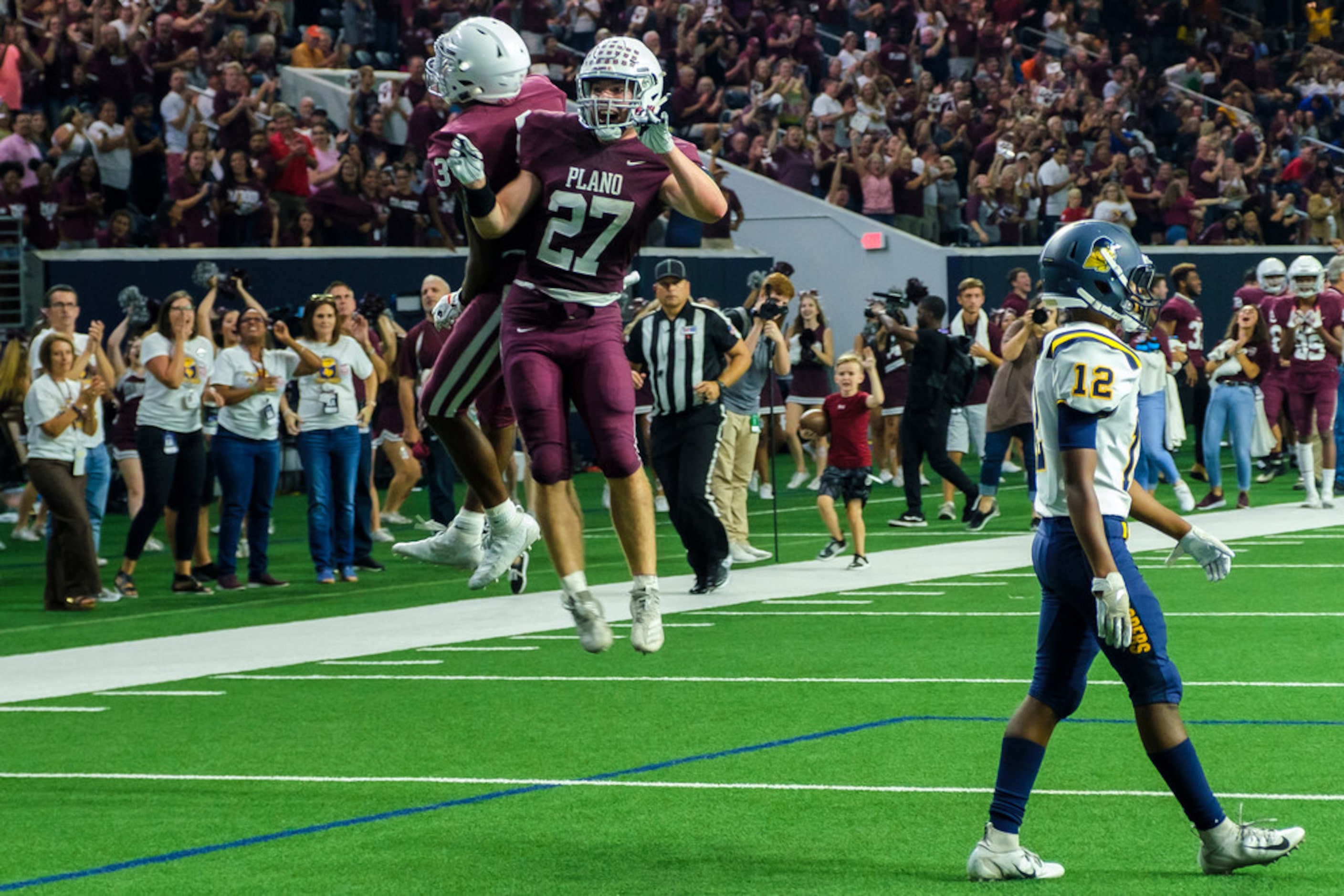 PlanoÃs Jayden Chambers (3) celebrates with running back Cody Crist (27) after scoring on a...