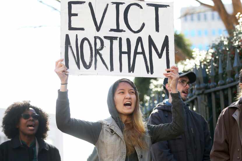 Geraldine Mabagos held a sign during a protest in Richmond, Va., calling for Gov. Ralph...