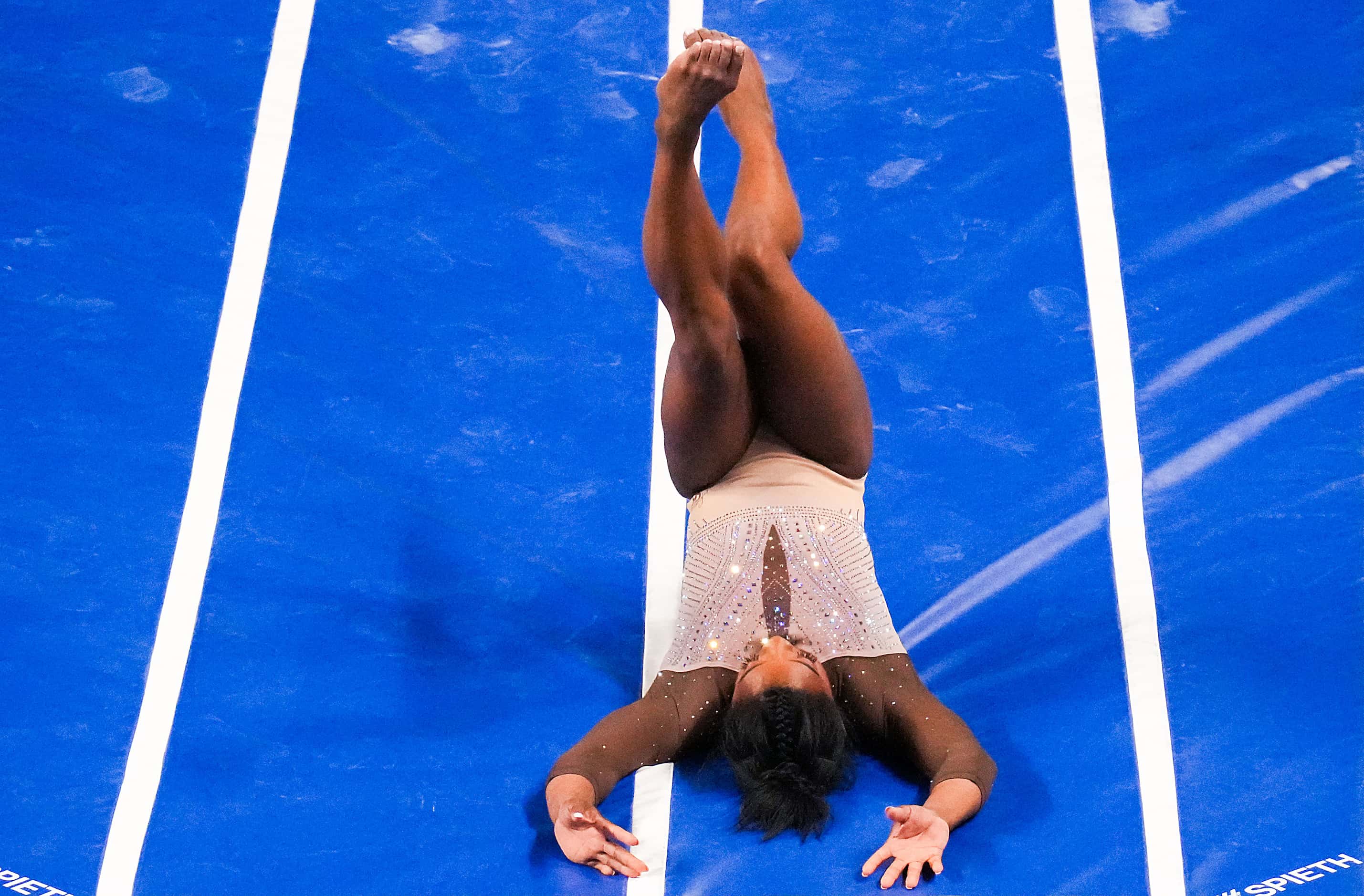 Simone Biles rolls backwards on her landing as she competes on the vault during the U.S....