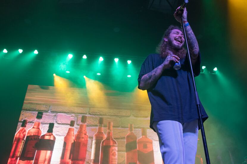 Post Malone holds a beer can while he performs at the Bomb Factory in Deep Ellum.