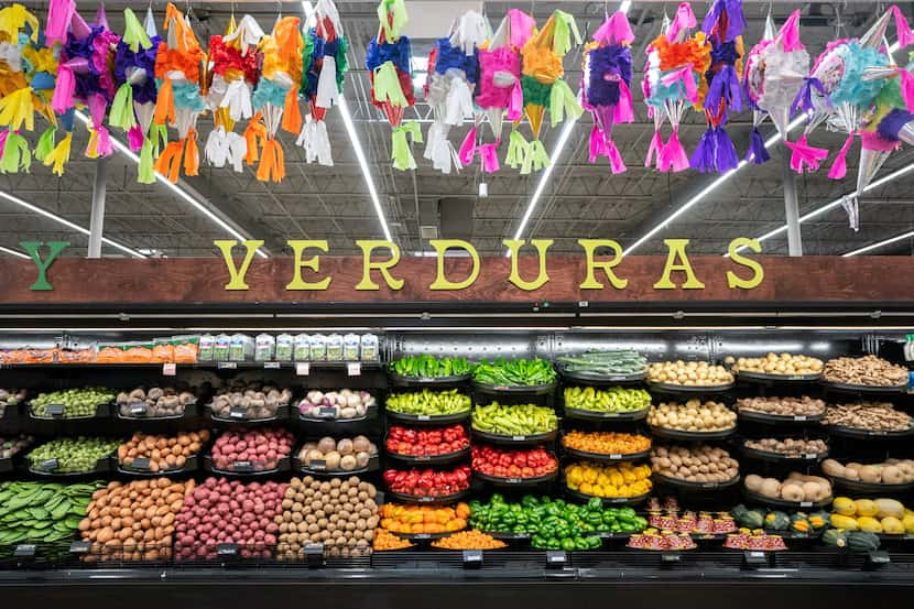 Piñatas hang above shelves stocked with vegetables in the newest El Rio Grande Latin Market...