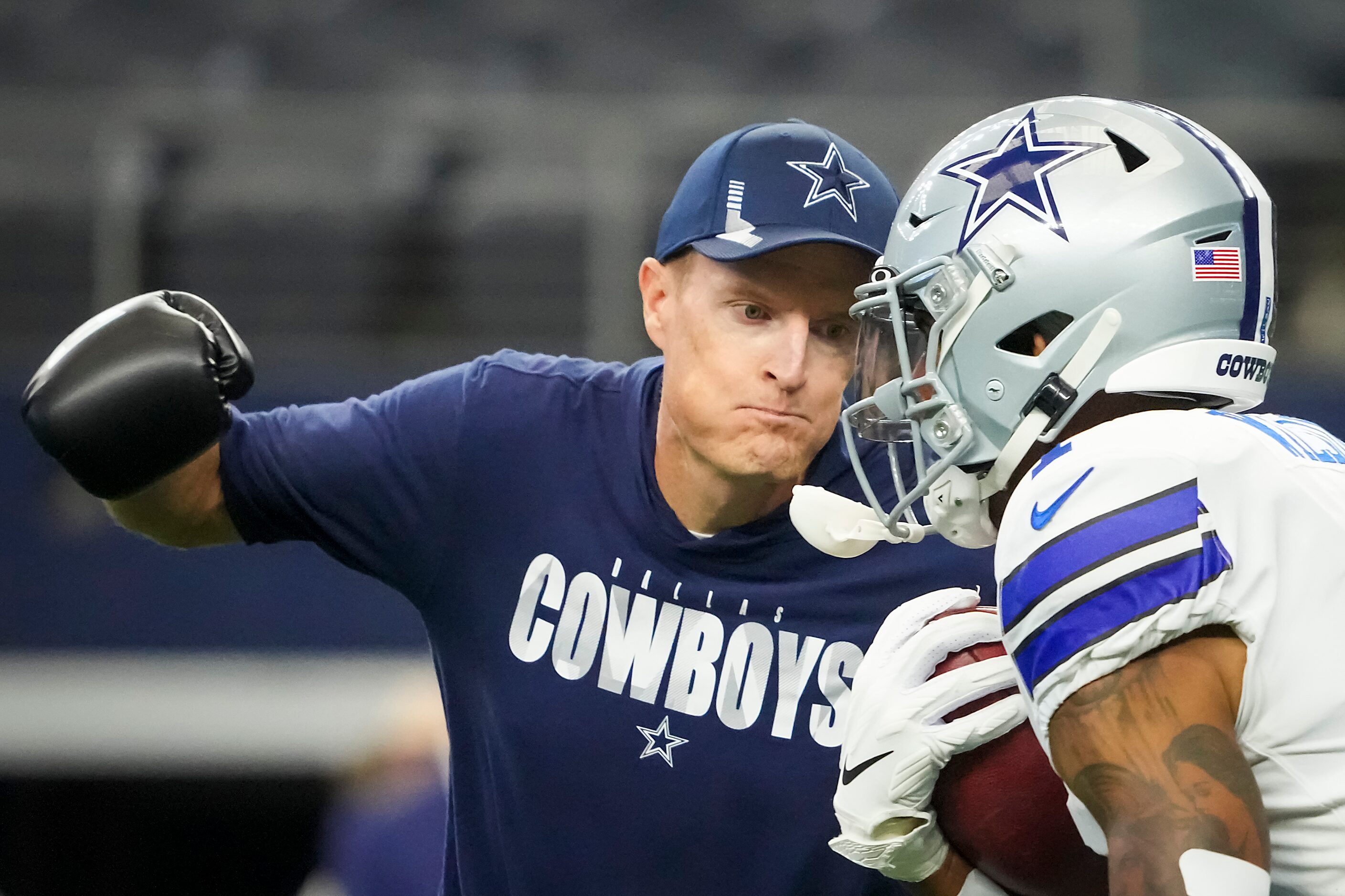 Dallas Cowboys special teams coordinator John Fassel works with wide receiver Ced Wilson...