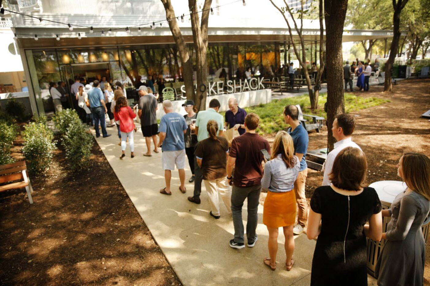 Lunchtime patrons lined up for the opening of Dallas' first Shake Shack on Pearl St. in...