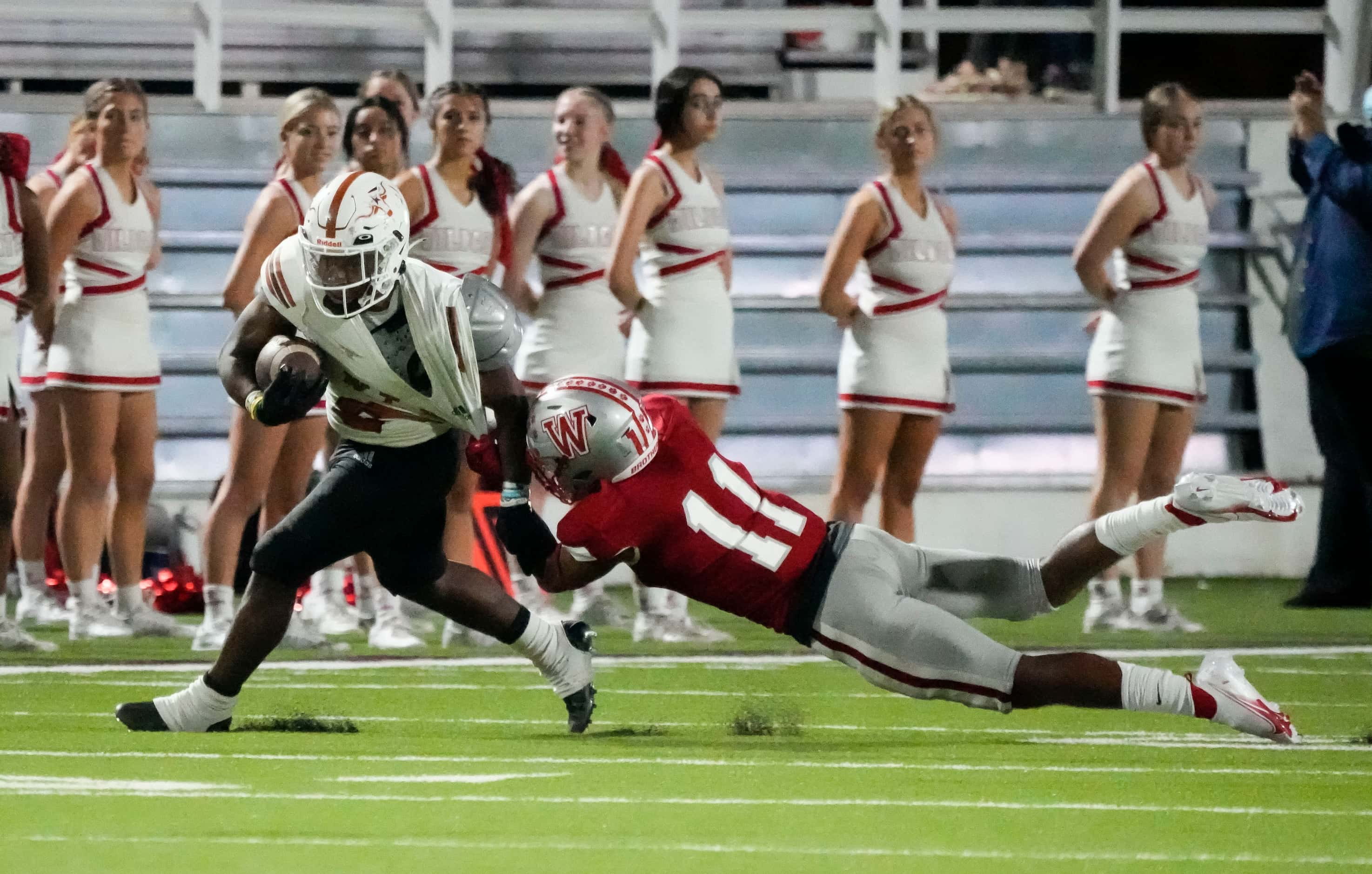 Woodrow Wilson junior defensive back Bryson Baggett (11) tackles W.T. White Daviawn Bishop...