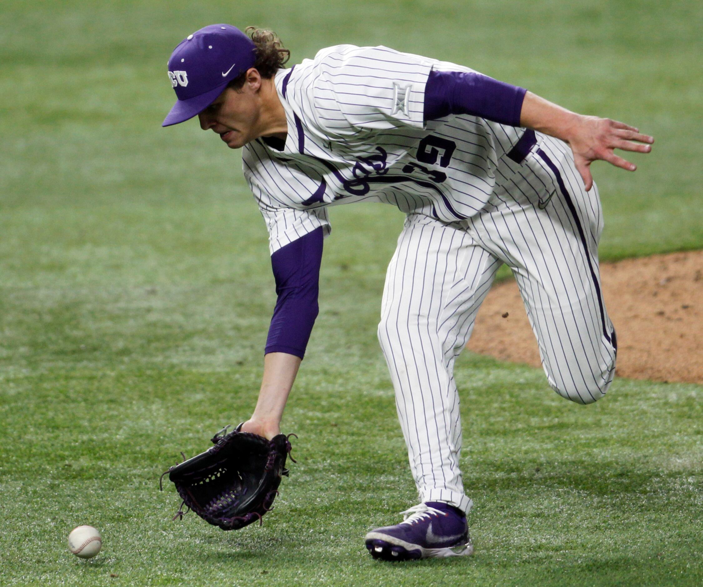 TCU pitcher Austin Krob (39) charges from the mound to field a bunt before throwing out the...
