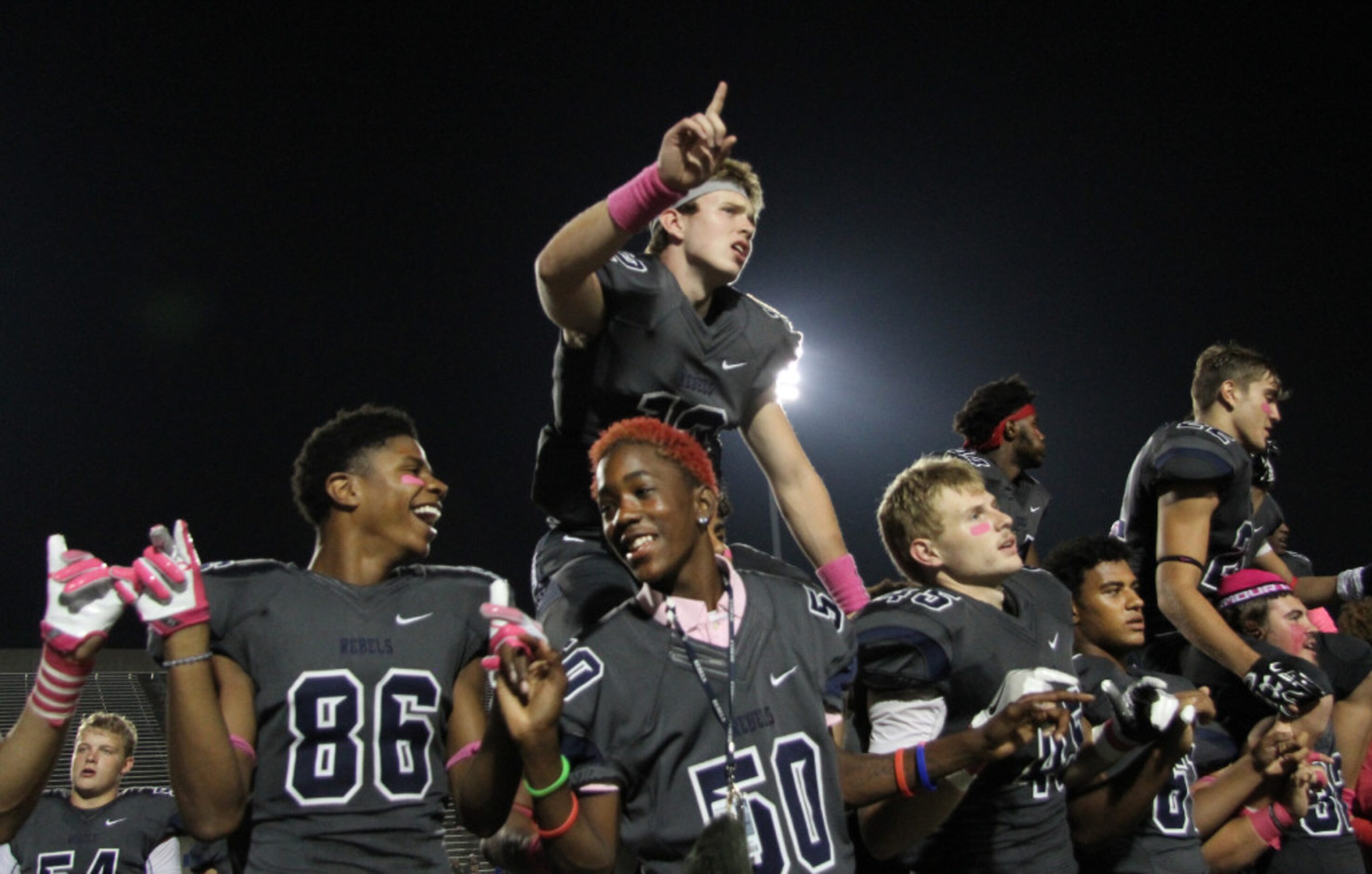 Richland Rebels pause for the playing of their school song following their 38-35 victory...