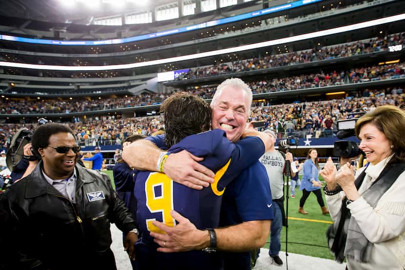 Highland Park quarterback John Stephen Jones (9) gets a hug from his father, Dallas Cowboys...