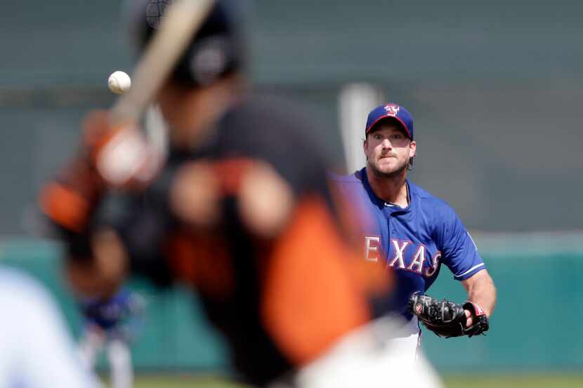 Texas Rangers starting pitcher Derek Lowe throws to the San Francisco Giants during an...