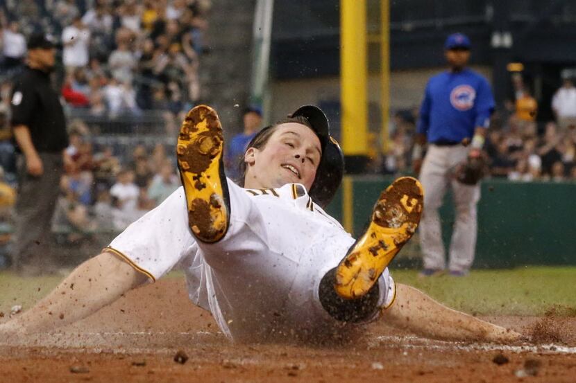 Pittsburgh Pirates Travis Snider slides safely across home plate on a double by Pirates...