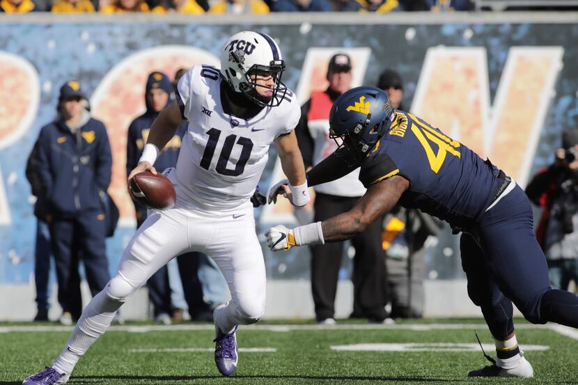TCU quarterback Michael Collins (10) is nearly sacked by West Virginia defensive lineman...