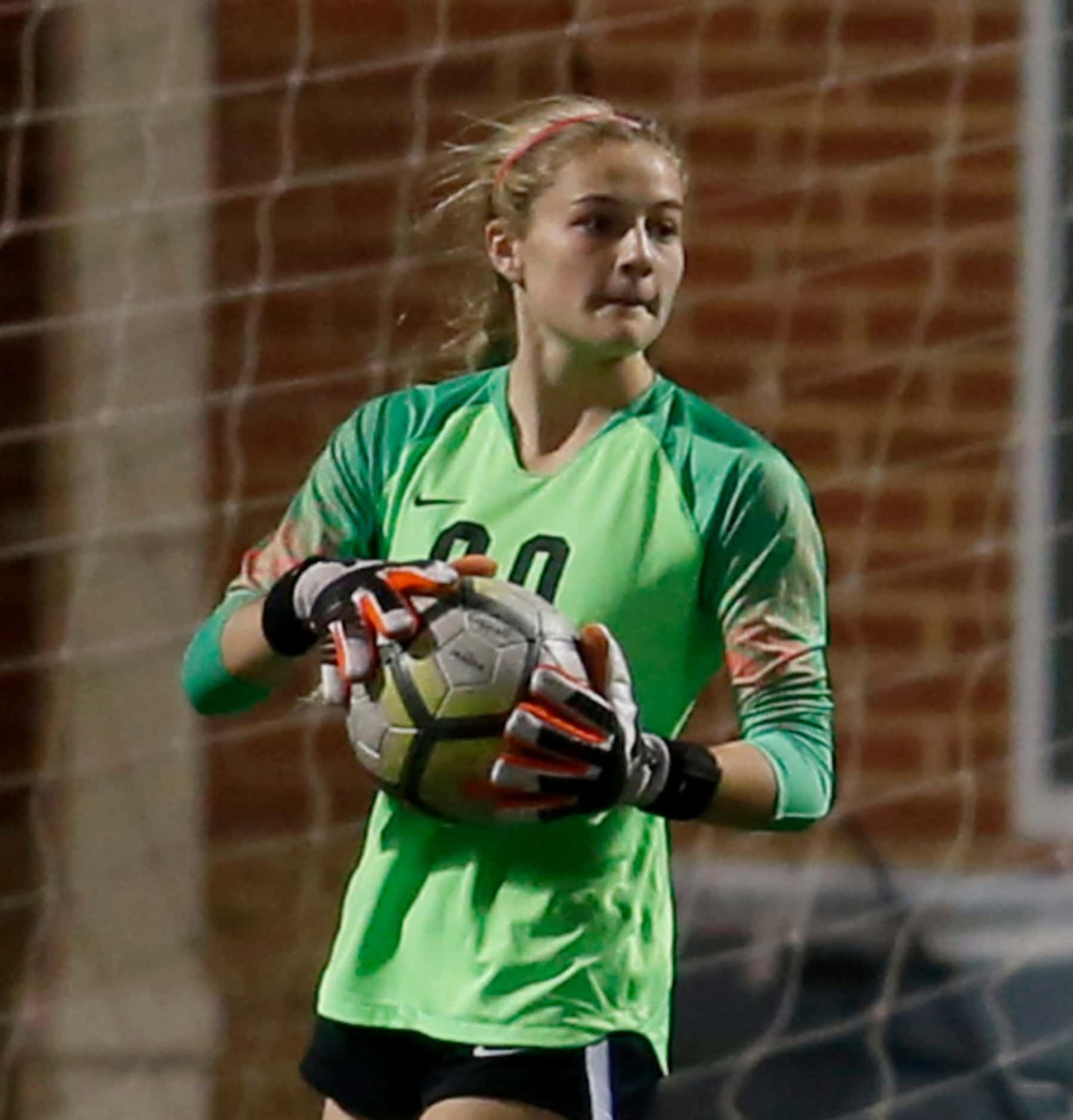 Coppell goalkeeper Lauren Kellett (00) surveys Keller's defensive set as she puts the ball...