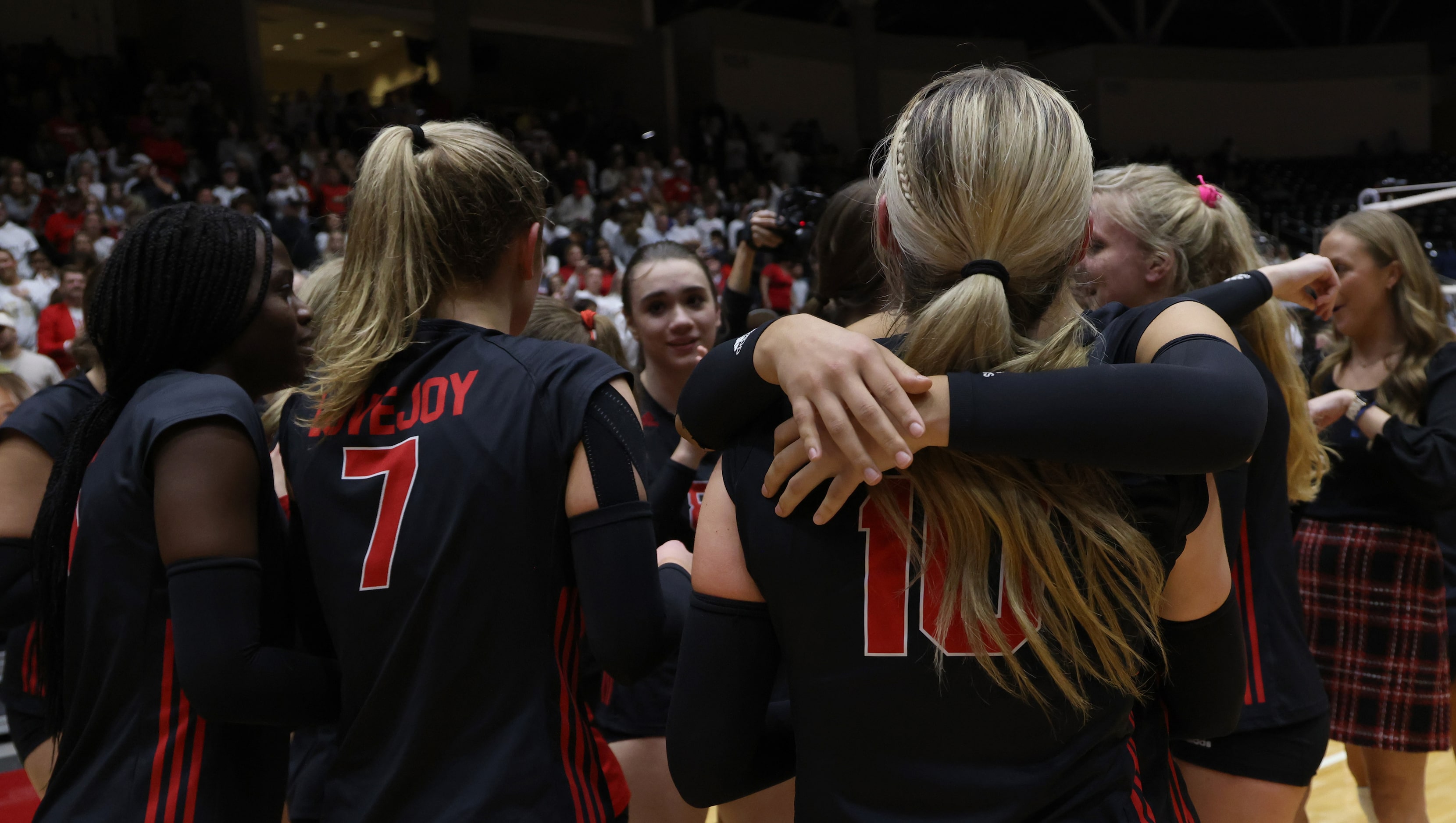 Lucas Lovejoy sophomore Skylar Jackson (10), right center, shares a hug with a teammate as...