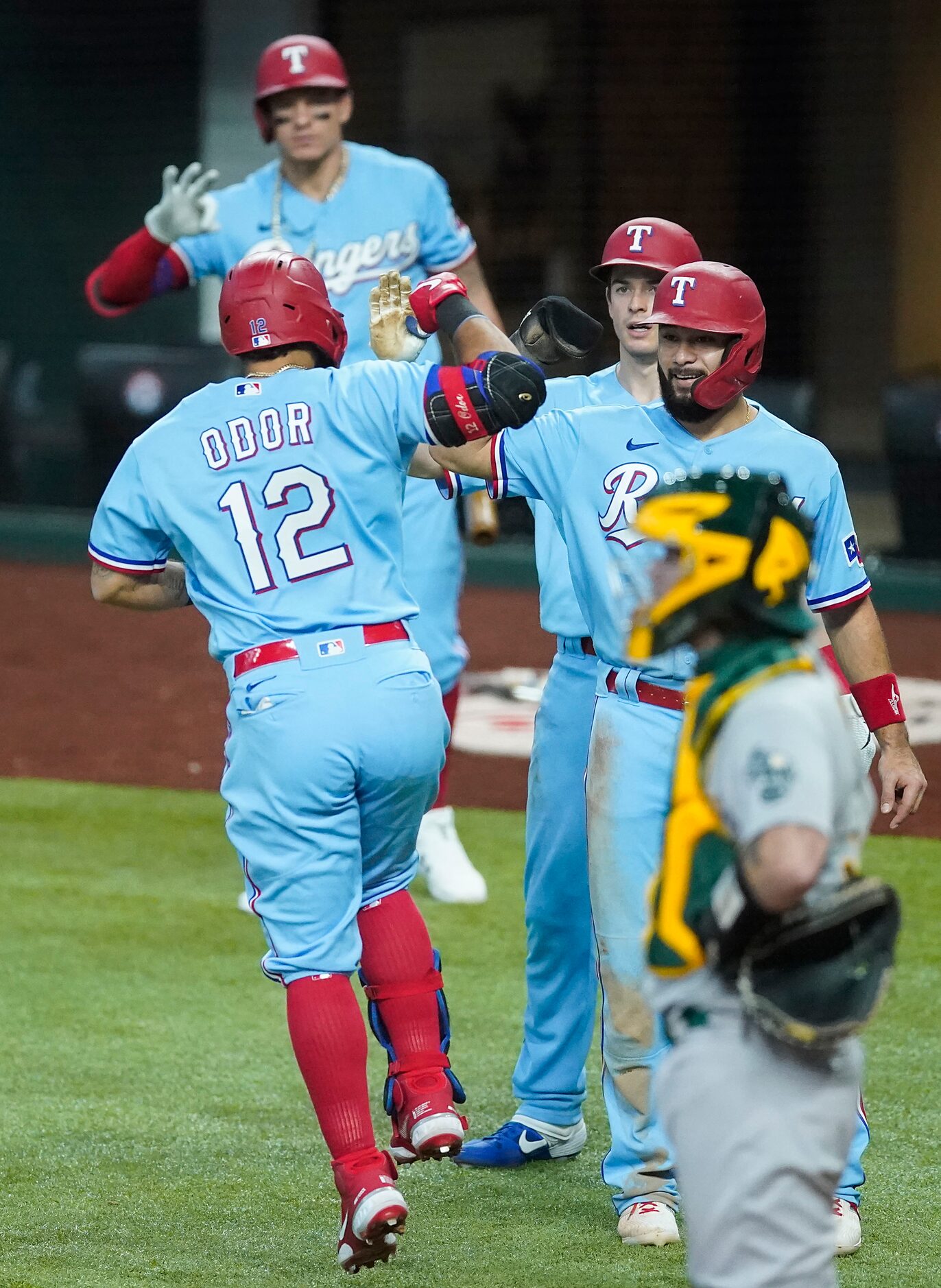 Texas Rangers second baseman Rougned Odor celebrates with third baseman Isiah Kiner-Falefa...