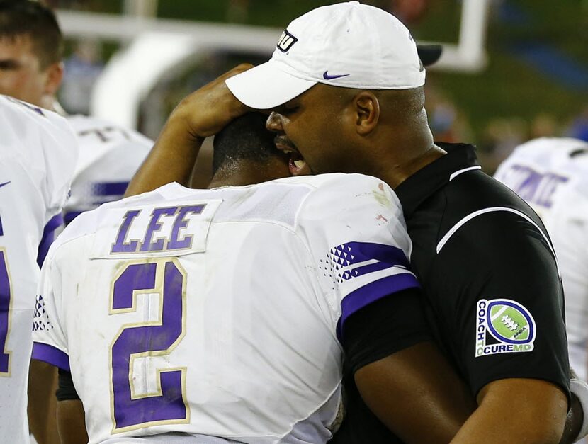 James Madison head coach Everett Withers talks with James Madison quarterback Vad Lee (2) ...