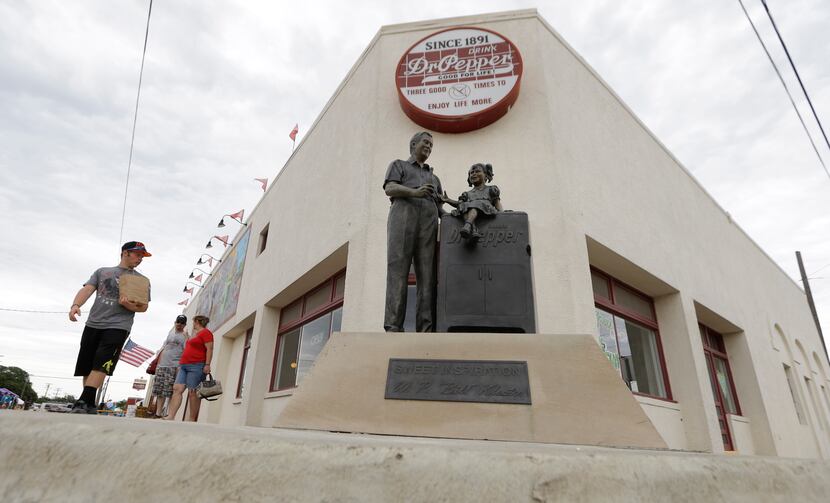 In this June 14, 2014 photo, visitors walk by the historic Dr. Pepper bottling plant in...