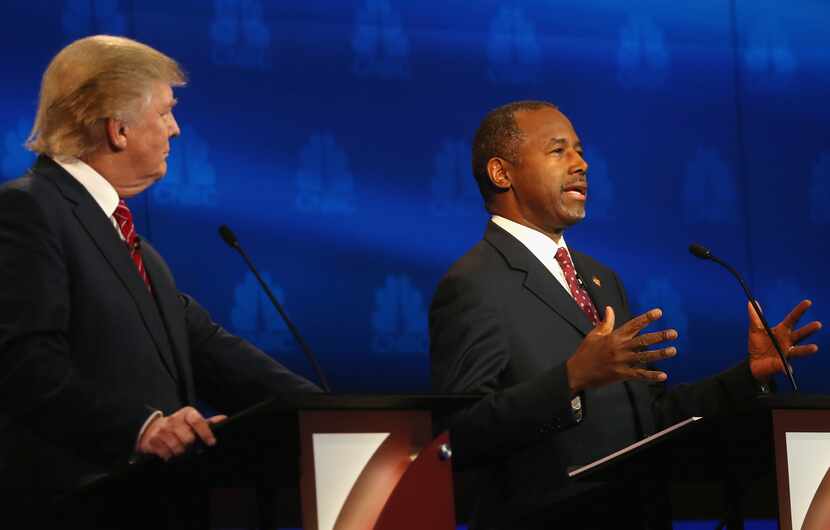 BOULDER, CO - OCTOBER 28:  Presidential candidate Ben Carson speaks while Donald Trump looks...