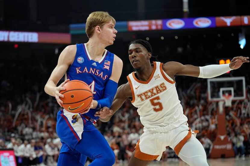 Kansas guard Gradey Dick (4) drives around Texas guard Marcus Carr (5)during the first half...