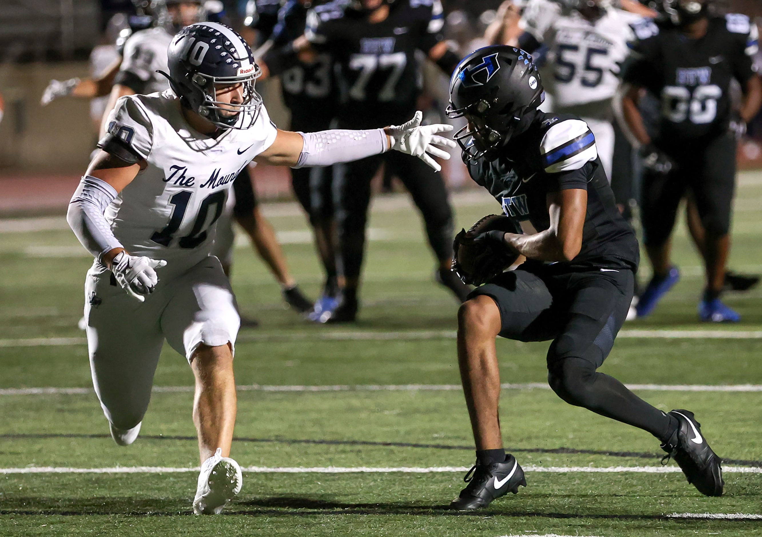 Hebron wide receiver Sheldon Armour (4) eludes Flower Mound linebacker Elijah Luneke (10)...