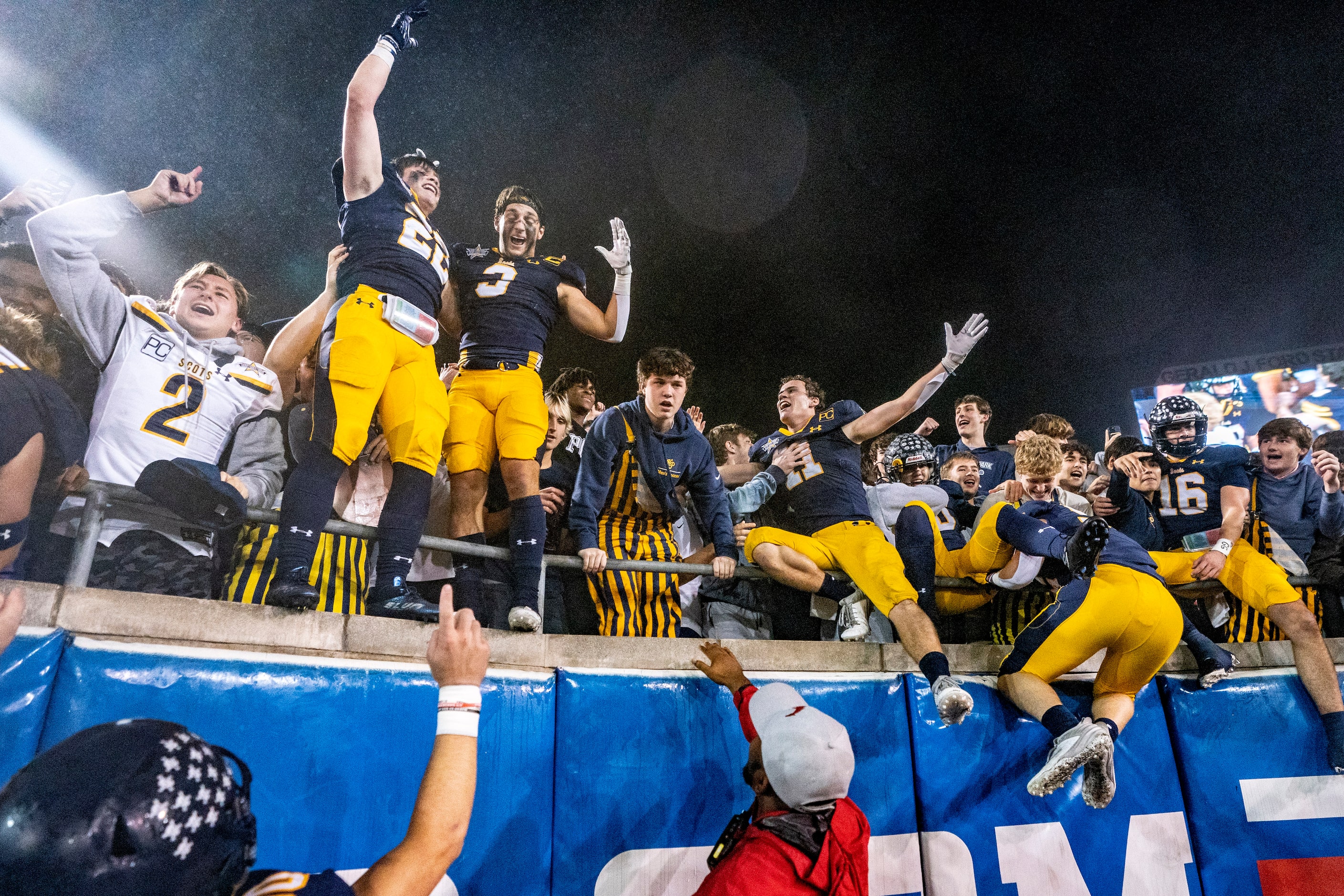 Highland Park players celebrate in the student section after beating McKinney 22-21 on a...