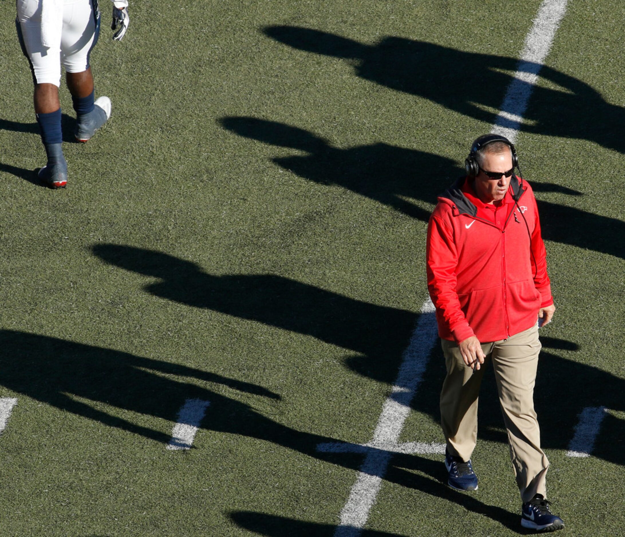 Allen head coach Terry Gambill steps onto the field to check the condition of an injured...