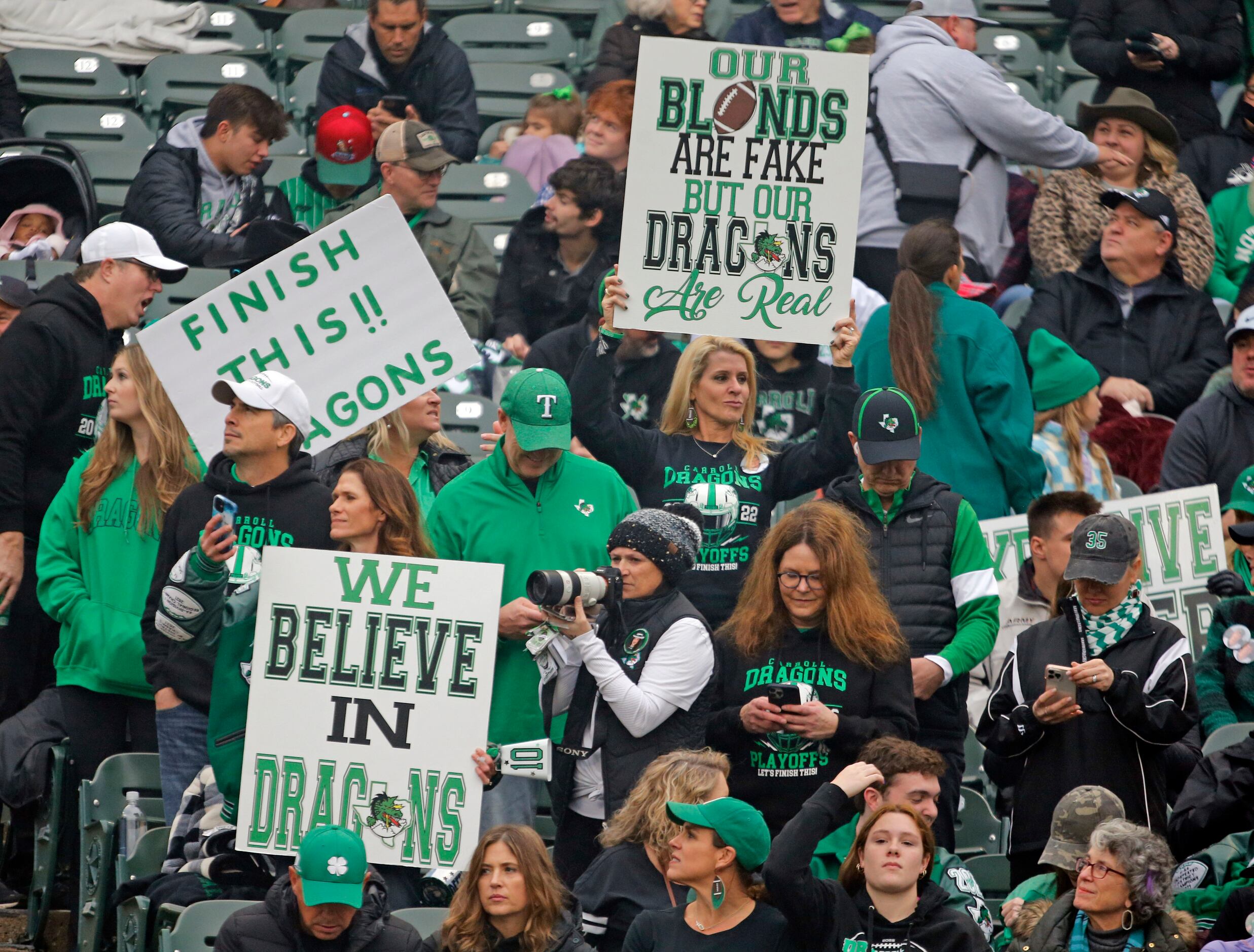 Southlake fans sport signs in the stands before the start of the Class 6A Division II Region...