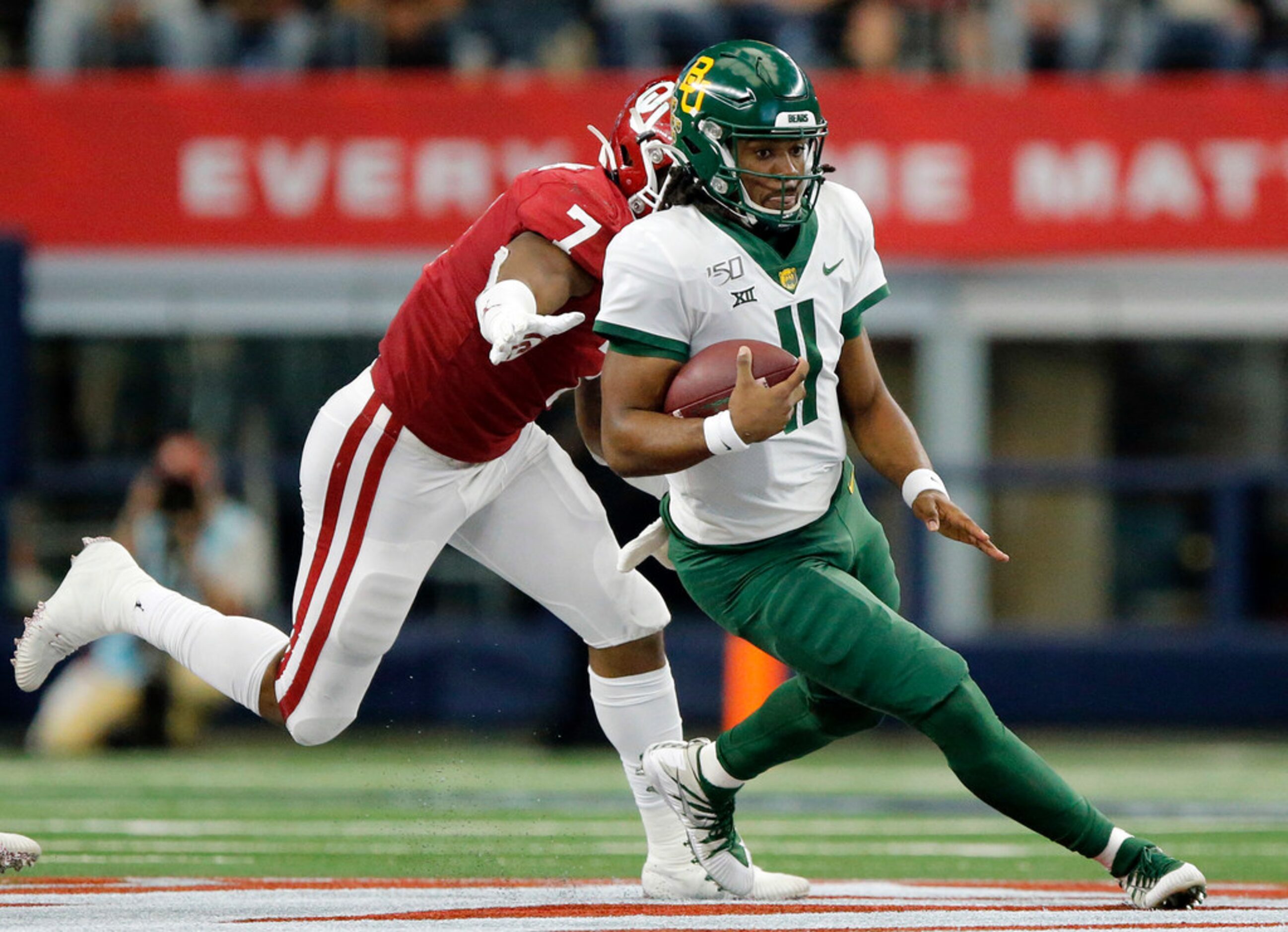 Baylor Bears quarterback Gerry Bohanon (11) keeps the ball and runs against Oklahoma Sooners...