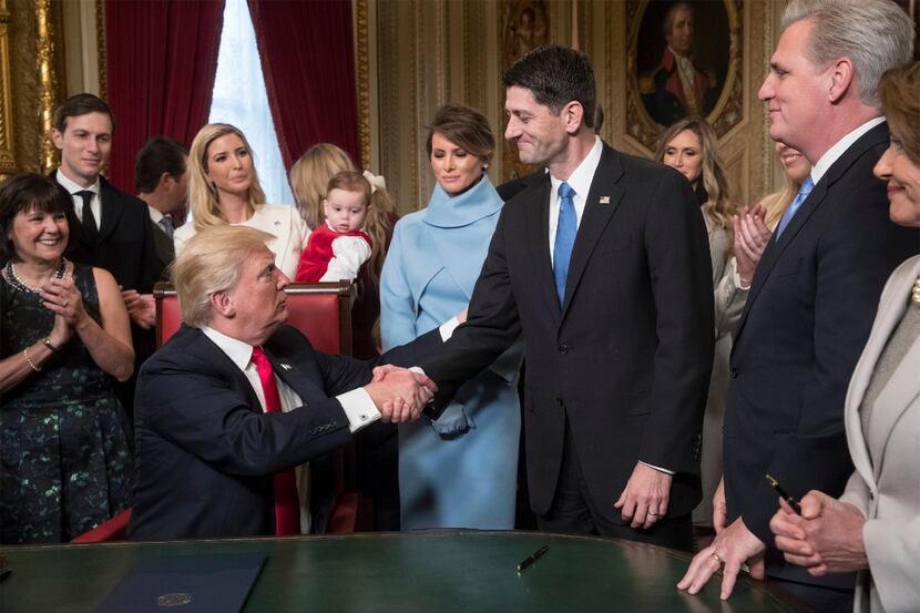 President Donald Trump turns to House Speaker Paul Ryan as he is joined by the Congressional...