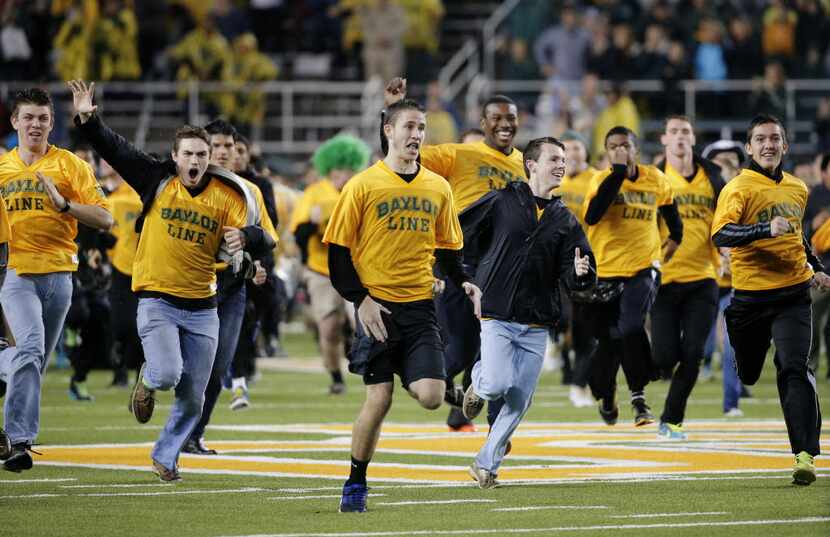 Baylor fans take the field before the Bears' 49-28 win over Oklahoma State Saturday,...
