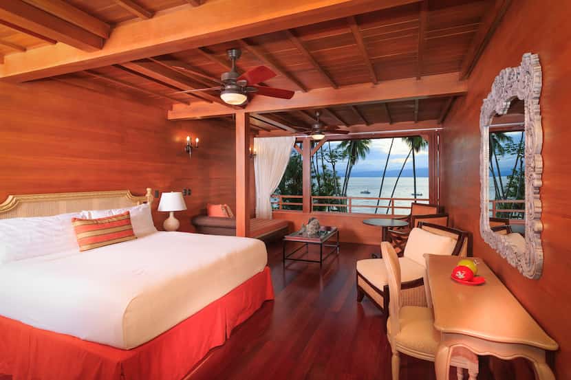 Playa Cativo Lodge offers 18 guest rooms with dark wood facades.