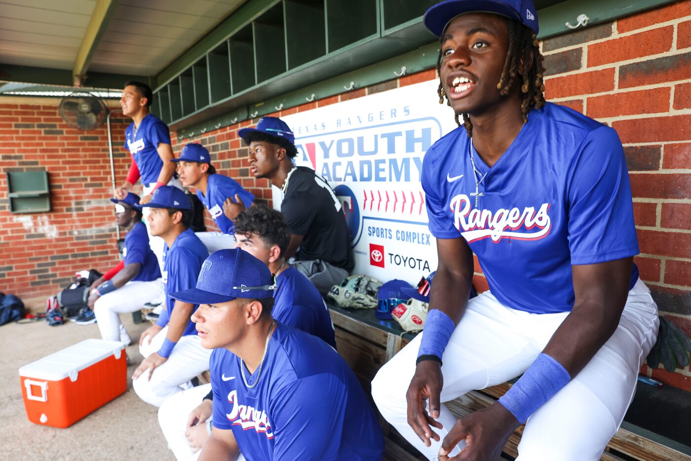 Texas Rangers youth players including Jayden Phillips (right) cheer for the team following a...