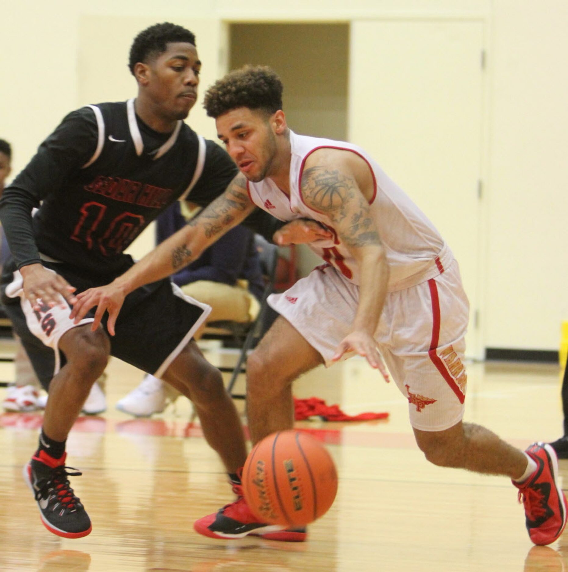 South Grand Prairie guard Andrew Montague (0) dribbles past the tight defense of Cedar Hill...