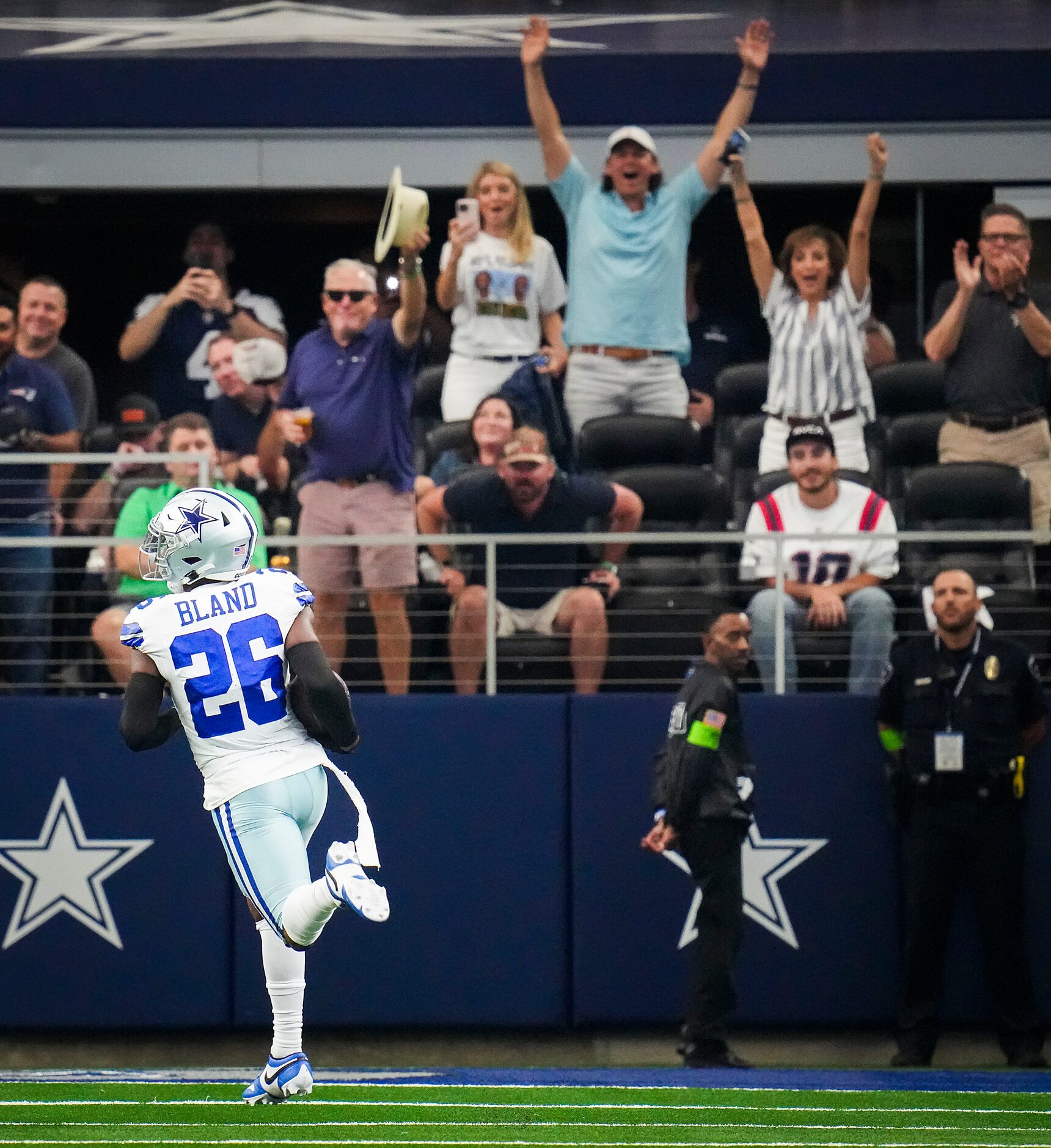 Fans cheer as Dallas Cowboys cornerback DaRon Bland returns an interception for a touchdown...