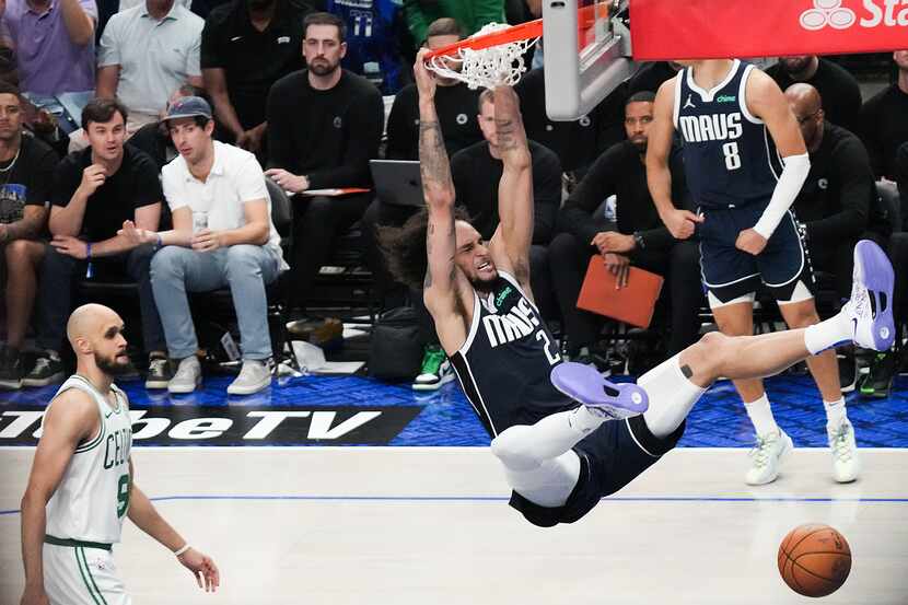Dallas Mavericks center Dereck Lively II (2) dunks the ball past Boston Celtics guard...