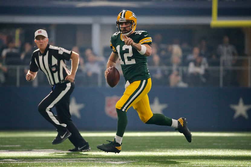 Green Bay Packers quarterback Aaron Rodgers (12) scrambles for a first down during the Green...
