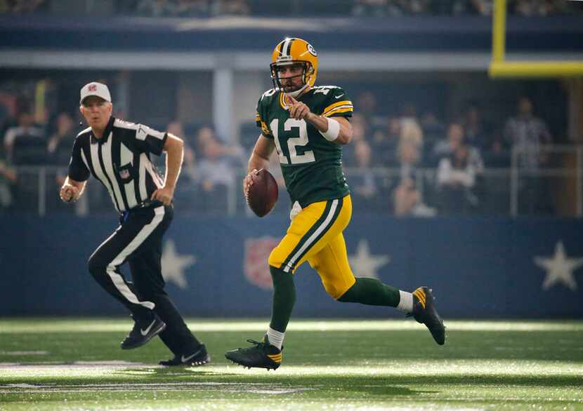 Green Bay Packers quarterback Aaron Rodgers (12) scrambles for a first down during the Green...