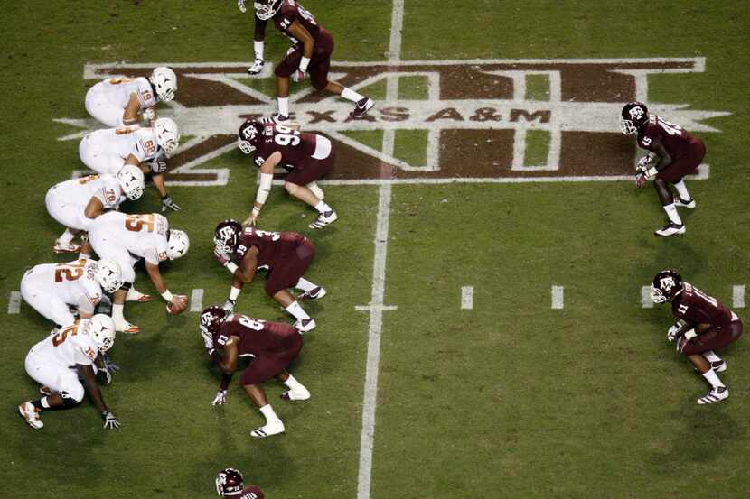 The Texas Longhorns offense forms over the Big 12 XII logo during the first half of the...