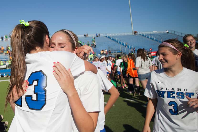 Plano West Ashley Smith hugs player Taylor Jackson after their win against Southlake Carroll...