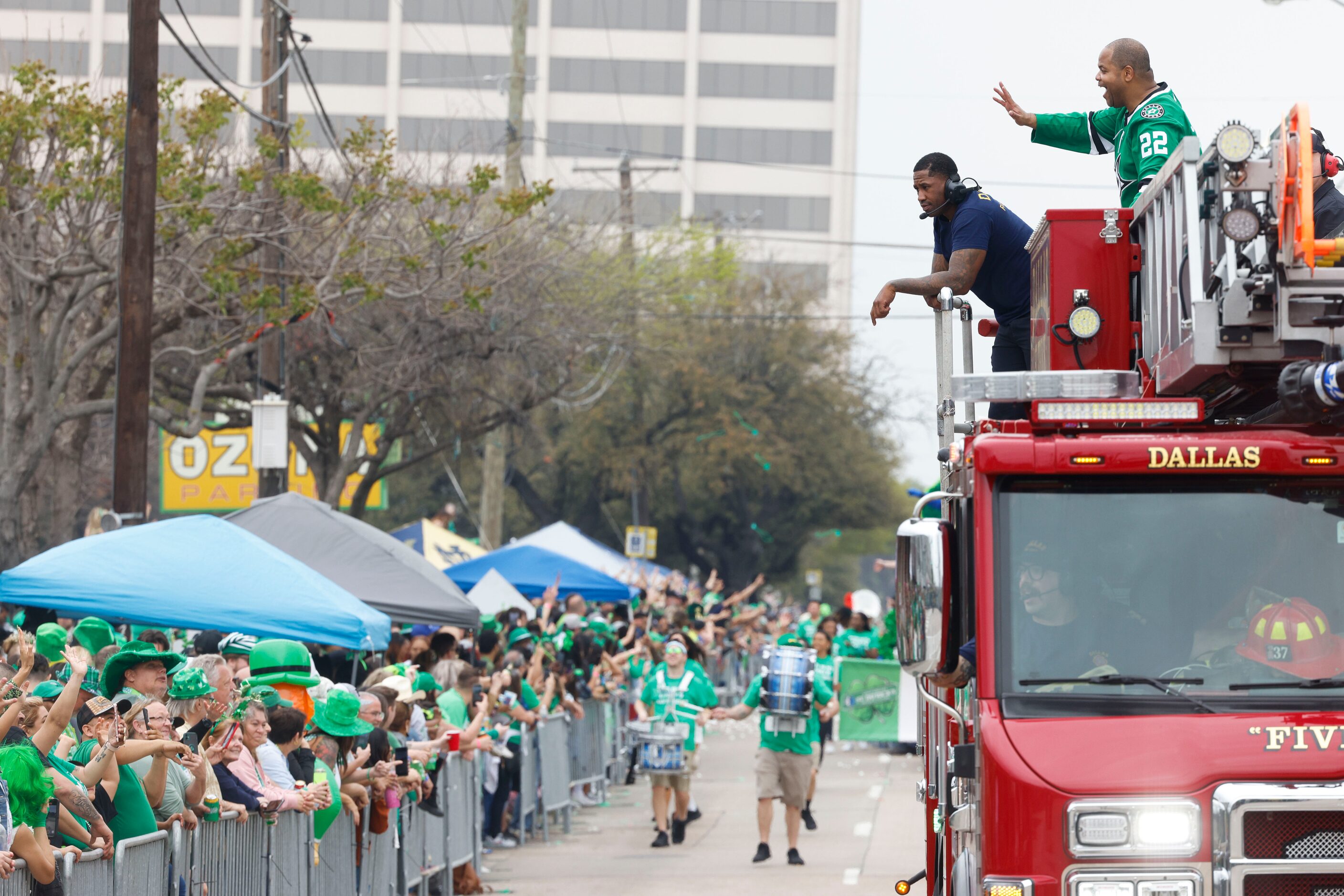 Dallas Mayor Eric Johnson waves towards the crowd during a Saint Patrick's Day parade on...