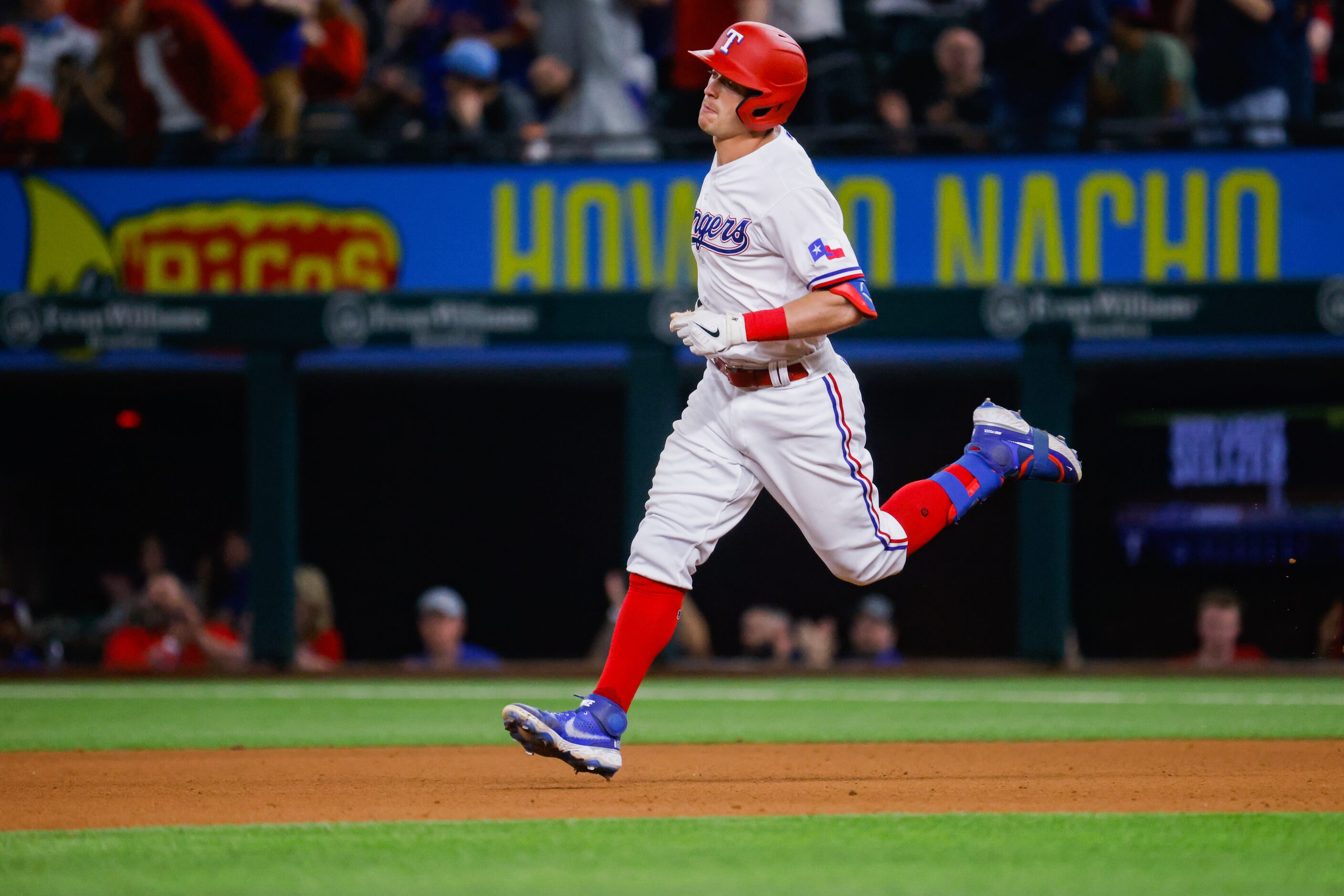 Texas Rangers second baseman Nick Solak (15) runs the bases after hitting a homer on a fly...