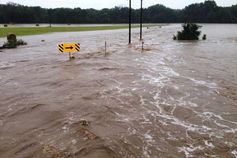 
A road off Interstate 35 in Sanger was temporarily a river on Thursday after the town...