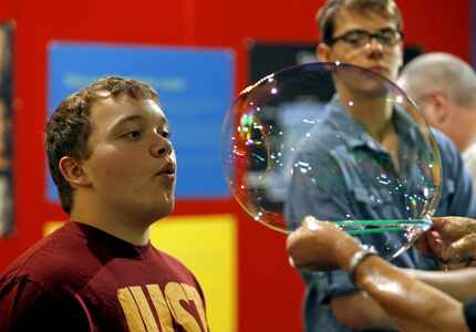 Jesse Allen, 14, of Collinsville, gets to launch a bubble from Linda Berman, "The...