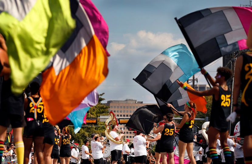 The Oak Lawn Band performs with the Black Gold Winterguard color guard in front of the Oak...