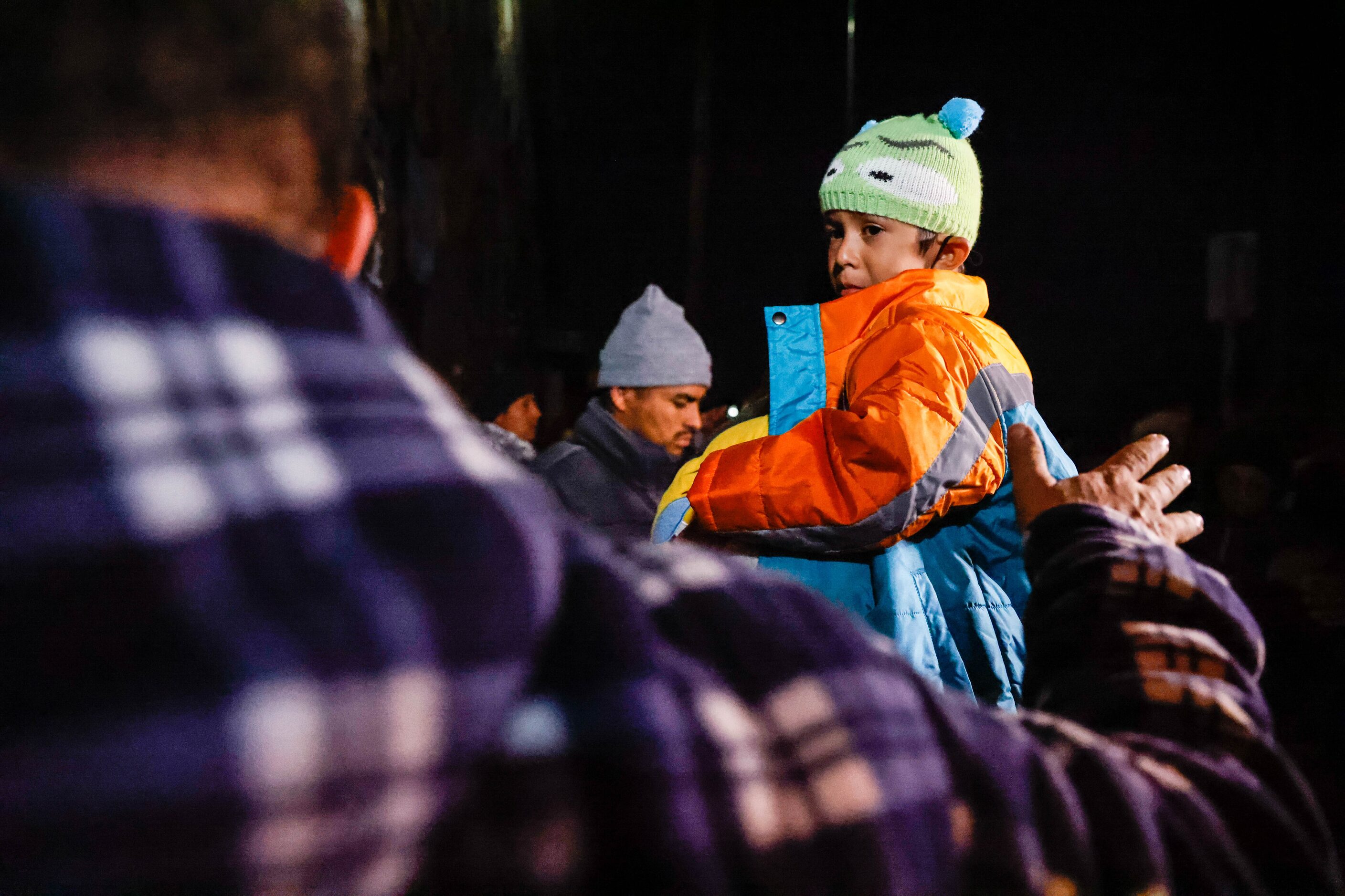 Migrants get inside the Centro Pastoral Sagrado Corazon in El Paso on Monday, Dec. 19, 2022....