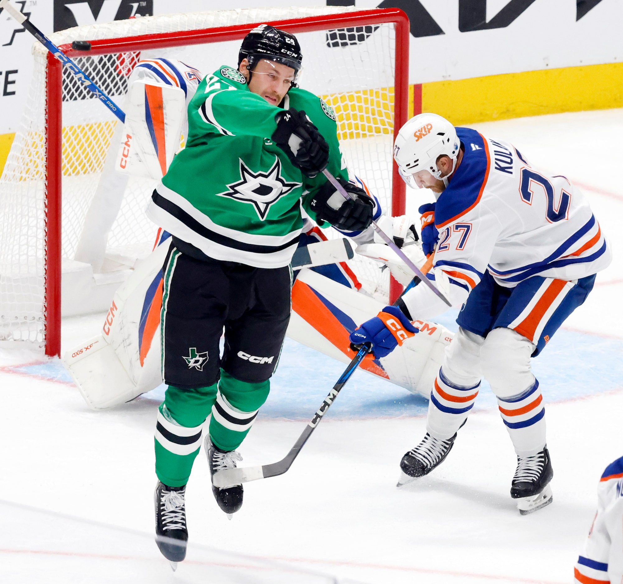 Dallas Stars center Roope Hintz (24) is tripped by Edmonton Oilers defenseman Brett Kulak...