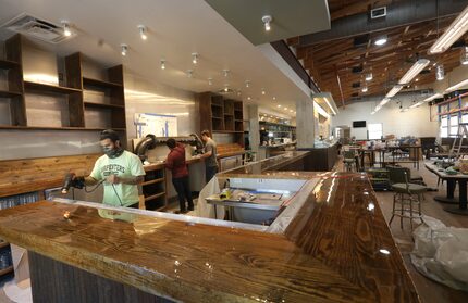 Ronald Bartiromo, left, David Herrera and Charles Nelson work inside Hurdy Gurdy. The...